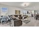 Spacious living room with tile floors, a large sectional sofa, and an open layout at 15914 Moonlight Bay St, Winter Garden, FL 34787