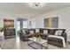 Bright living room features tile flooring, recessed lighting, and sliding glass doors to the lanai at 15914 Moonlight Bay St, Winter Garden, FL 34787