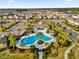 Aerial view of a community pool surrounded by palm trees and beautiful landscaping at 15914 Moonlight Bay St, Winter Garden, FL 34787