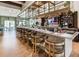 Chic bar with a long counter, modern stools, glass shelving, and a TV, perfect for socializing and enjoying refreshments at 1731 Caribbean View Ter, Kissimmee, FL 34747