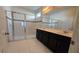 Bathroom featuring dual sinks, tiled floors, a soaking tub, and a glass shower enclosure at 1731 Caribbean View Ter, Kissimmee, FL 34747