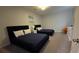 This bedroom features carpet flooring, two beds with navy blue bedding, and modern decor at 1731 Caribbean View Ter, Kissimmee, FL 34747