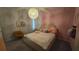 Bedroom with a bed, chair, and pink walls at 1731 Caribbean View Ter, Kissimmee, FL 34747