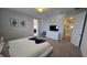 A brightly lit bedroom features carpet flooring, a large dresser, and decoratively framed artwork at 1731 Caribbean View Ter, Kissimmee, FL 34747
