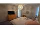 Bedroom with a bed, dresser, and whimsical light fixture at 1731 Caribbean View Ter, Kissimmee, FL 34747