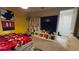 Playful bedroom with yellow and blue walls, a TV, and themed decor at 1731 Caribbean View Ter, Kissimmee, FL 34747