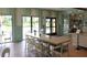 Bright cafe area featuring a long marble table, trendy seating, and ample natural light, perfect for casual gatherings at 1731 Caribbean View Ter, Kissimmee, FL 34747