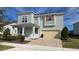 Charming two-story home featuring a covered porch and a two-car garage with a beautifully landscaped front yard at 1731 Caribbean View Ter, Kissimmee, FL 34747
