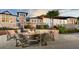 Inviting outdoor fire pit area with comfortable Adirondack chairs surrounded by lush landscaping and an elegant clubhouse at 1731 Caribbean View Ter, Kissimmee, FL 34747