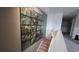 Hallway featuring stairs and large botanical artwork that spans almost the entire wall at 1731 Caribbean View Ter, Kissimmee, FL 34747