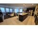 Open-concept kitchen with island, stainless steel appliances, and dining area at 1731 Caribbean View Ter, Kissimmee, FL 34747