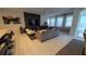 Spacious living room with tile floors, modern decor, and lots of natural light at 1731 Caribbean View Ter, Kissimmee, FL 34747