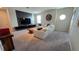 Upstairs living room with modern furniture, a media wall, and cozy carpet at 1731 Caribbean View Ter, Kissimmee, FL 34747