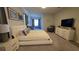 Bright main bedroom with a king bed, stylish decor, and access to the ensuite at 1731 Caribbean View Ter, Kissimmee, FL 34747