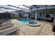 Beautiful pool and jacuzzi in screened-in lanai with outdoor dining and seating area at 1731 Caribbean View Ter, Kissimmee, FL 34747