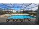 Screened-in pool area features a pool and spa at 1731 Caribbean View Ter, Kissimmee, FL 34747
