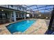Beautiful pool and jacuzzi in screened-in lanai with outdoor dining and seating area at 1731 Caribbean View Ter, Kissimmee, FL 34747