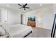 Minimalist bedroom with a queen bed, neutral tones, natural light, and a TV on a dresser at 2012 Keystone Pass Blvd, Minneola, FL 34715