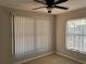Cozy bedroom with plush carpeting, a ceiling fan, and natural light from two windows at 2013 Bates Ave, Eustis, FL 32726