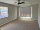 Bright bedroom with light carpet and two windows illuminating the room at 2013 Bates Ave, Eustis, FL 32726