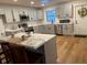 Modern kitchen with gray cabinets, stainless steel appliances, and an island with seating at 2013 Bates Ave, Eustis, FL 32726