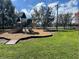 Community playground area with slides and climbing structures, near a picturesque lake at 2013 Bates Ave, Eustis, FL 32726