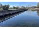 Scenic view of a serene pond with a wooden bridge under a clear blue sky at 2013 Bates Ave, Eustis, FL 32726
