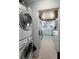 View from the laundry room of a bright kitchen with stainless appliances, light blue cabinets, and white marble counter tops at 2045 Green Cedar Ln, Geneva, FL 32732