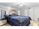 Main bedroom boasts mirrored wall, ceiling fan, and ensuite bathroom access at 21 Aspen Dr # 21, Haines City, FL 33844