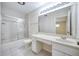 A bright bathroom featuring a vanity with ample counter space and a shower with glass door at 2123 Alameda St, Orlando, FL 32804