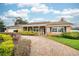 Charming brick home featuring manicured landscaping, a brick driveway and welcoming front porch at 2123 Alameda St, Orlando, FL 32804