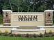 Welcoming entrance sign for Oak Leaf Preserve with stone accents and a serene water feature at 2220 Lake Preserve Cir, New Smyrna Beach, FL 32168