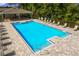 Community pool with lounge chairs and sunbathing deck at 2222 Lake Preserve Cir, New Smyrna Beach, FL 32168