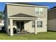 Back of home featuring covered lanai with outdoor seating, complemented by a well-kept lawn at 2369 Palm Park Loop, Clermont, FL 34714