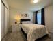 A cozy bedroom features a comfortable bed, a dresser, and window, creating a relaxing retreat at 2369 Palm Park Loop, Clermont, FL 34714