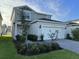 Charming two-story home with a well-maintained lawn and a brick paver driveway at 2369 Palm Park Loop, Clermont, FL 34714