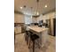 Modern kitchen with white cabinets, stainless steel appliances, tile floors and center island with breakfast bar at 2369 Palm Park Loop, Clermont, FL 34714
