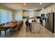 Bright kitchen features stainless steel appliances, an island with bar seating, and an adjacent dining area at 2369 Palm Park Loop, Clermont, FL 34714