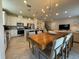 Stylish eat-in kitchen features modern appliances, ample countertop space, and adjacent dining area at 2369 Palm Park Loop, Clermont, FL 34714