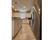 Kitchen includes stainless steel refrigerator and white cabinets, offering style and functionality for cooking at 2369 Palm Park Loop, Clermont, FL 34714