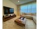 Cozy living room with tiled floors, large windows and a comfortable sectional sofa at 2369 Palm Park Loop, Clermont, FL 34714