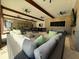 Inviting patio with beamed ceiling, fans, comfortable seating, and outdoor dining, perfect for entertaining at 2369 Palm Park Loop, Clermont, FL 34714