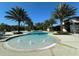 Stunning community pool surrounded by lush landscaping and palm trees at 2369 Palm Park Loop, Clermont, FL 34714