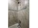 Close-up of a shower featuring a tiled wall with mosaic accents at 2369 Palm Park Loop, Clermont, FL 34714