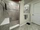 Luxurious walk-in shower with tile surround, built-in bench, and mosaic accents at 2369 Palm Park Loop, Clermont, FL 34714
