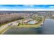 Aerial view of community pool and lake surrounded by trees and residential homes at 2479 Empress Dr, Kissimmee, FL 34741