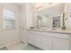 Bathroom featuring a double vanity with white cabinets, large mirror, and ample lighting at 2623 Buena View Rd, Kissimmee, FL 34746