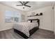 Contemporary bedroom with wood floors, ceiling fan, and modern decor at 2623 Buena View Rd, Kissimmee, FL 34746