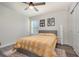 Bright bedroom with a yellow quilt, a ceiling fan, and a window allowing ample natural light at 2623 Buena View Rd, Kissimmee, FL 34746