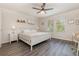 Comfortable bedroom featuring wood flooring, a large bed, and natural light from the windows at 2623 Buena View Rd, Kissimmee, FL 34746